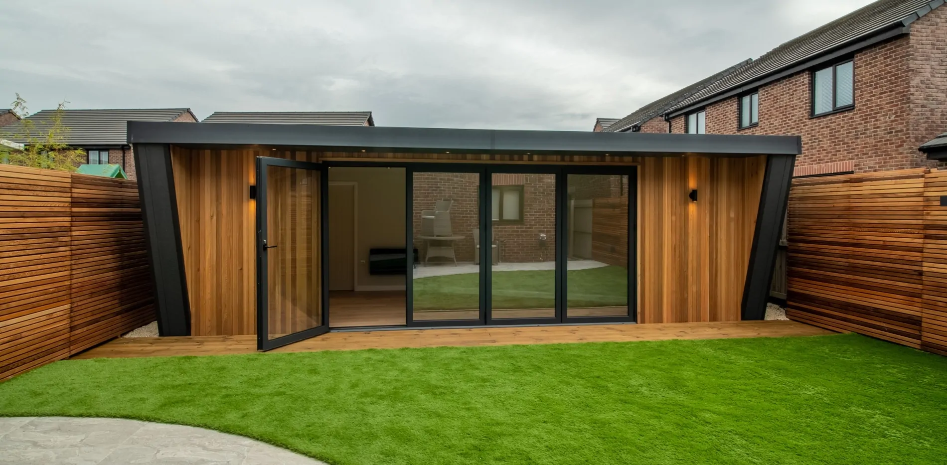 A garden room with an open glass panel door